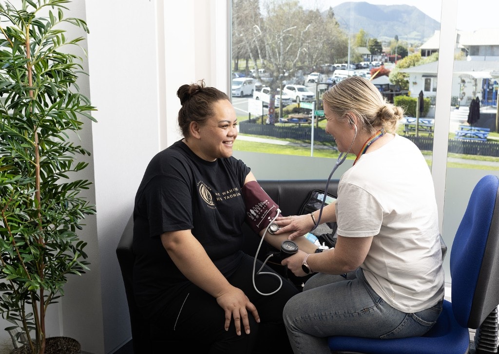Healthcare professional checking blood pressure